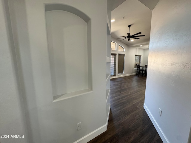 hallway featuring lofted ceiling and dark hardwood / wood-style flooring