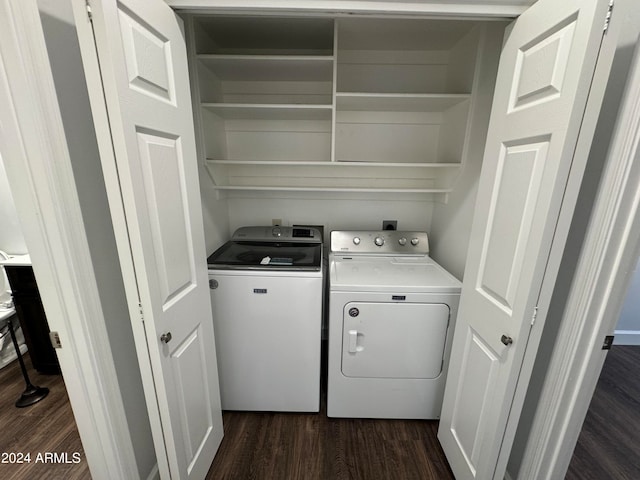 clothes washing area with dark hardwood / wood-style floors and washing machine and clothes dryer