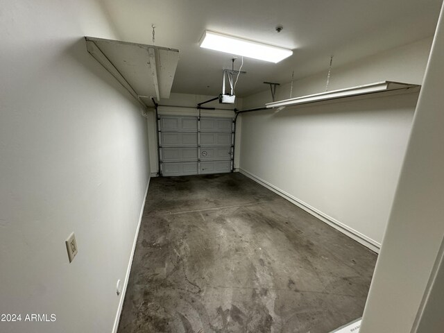 14000 N 94th St Unit 1037, Scottsdale, AZ 85260 - garage featuring a garage door opener and baseboards