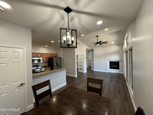 14000 N 94th St Unit 1037, Scottsdale, AZ 85260 - kitchen with brown cabinets, dark wood-style flooring, stainless steel appliances, baseboards, and ceiling fan with notable chandelier
