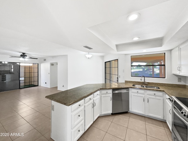 12342 S Shoshoni Dr, Phoenix, AZ 85044 - kitchen with appliances with stainless steel finishes, a sink, a peninsula, light tile patterned flooring, and white cabinetry