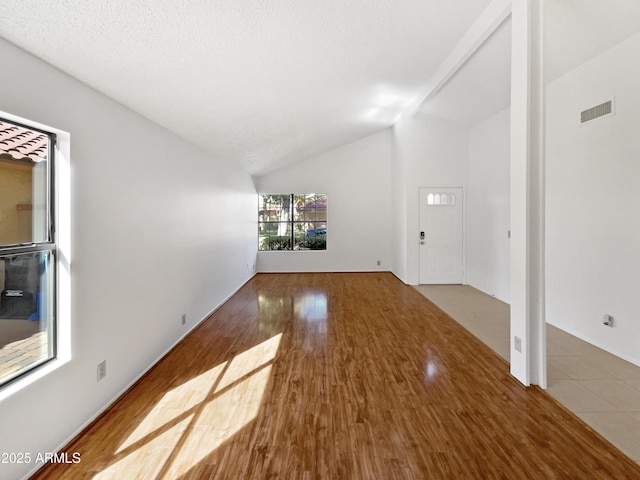 12342 S Shoshoni Dr, Phoenix, AZ 85044 - unfurnished living room with lofted ceiling and wood finished floors