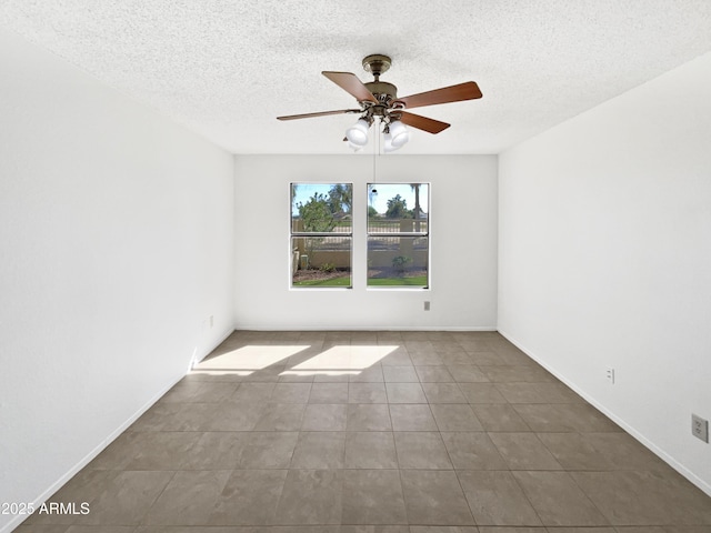 12342 S Shoshoni Dr, Phoenix, AZ 85044 - spare room with ceiling fan, a textured ceiling, tile patterned flooring, and baseboards
