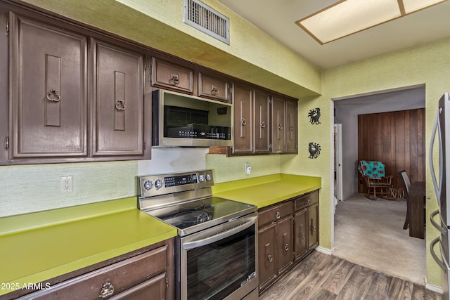 8540 N 43rd Dr, Glendale, AZ 85302 - kitchen featuring stainless steel appliances, dark wood-style floors, dark brown cabinets, decorative backsplash, and light countertops