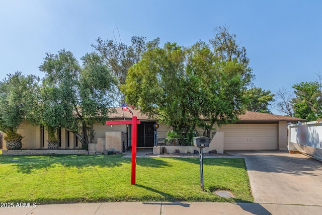8540 N 43rd Dr, Glendale, AZ 85302 - obstructed view of property with stucco siding, driveway, and a front lawn