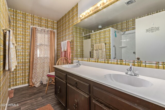 8540 N 43rd Dr, Glendale, AZ 85302 - full bathroom featuring wood finished floors, wallpapered walls, a shower, and double vanity