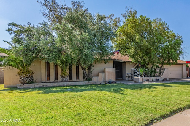 8540 N 43rd Dr, Glendale, AZ 85302 - view of front facade with stucco siding, an attached garage, and a front yard
