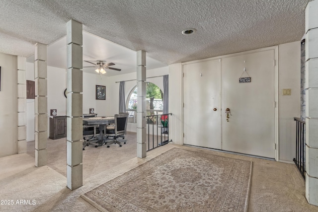 8540 N 43rd Dr, Glendale, AZ 85302 - foyer entrance with light colored carpet, a textured ceiling, and a ceiling fan
