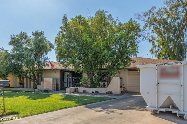 8540 N 43rd Dr, Glendale, AZ 85302 - view of front facade with stucco siding, concrete driveway, and a front yard