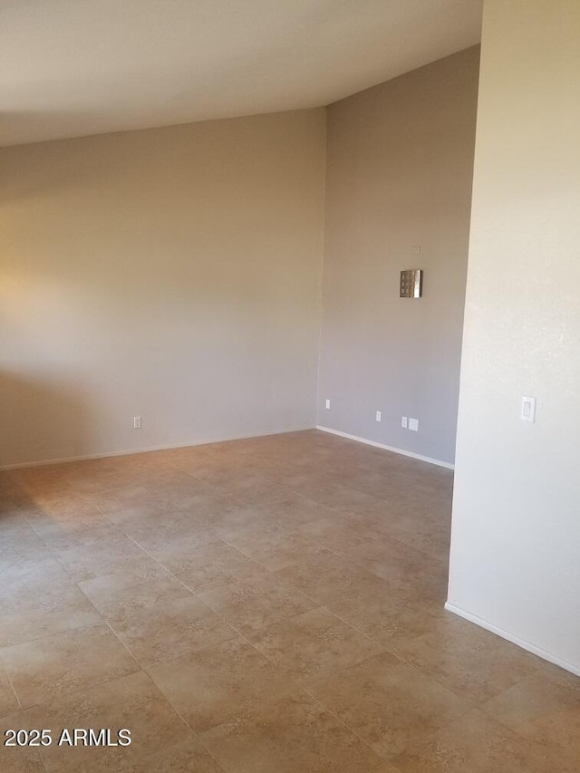 unfurnished room featuring baseboards