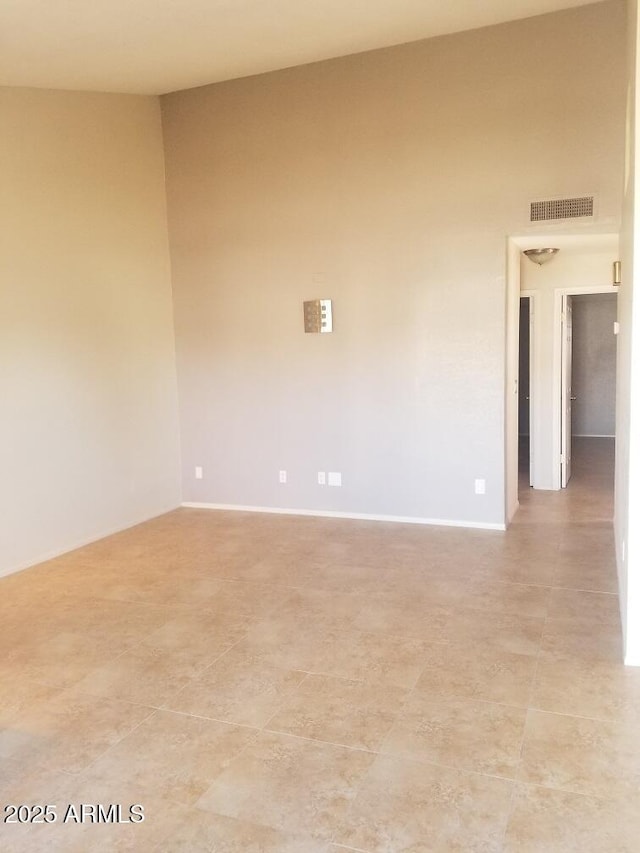 unfurnished room featuring visible vents