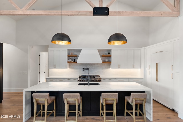 1013 W Ardmore Rd, Phoenix, AZ 85041 - kitchen with custom exhaust hood, high vaulted ceiling, open shelves, a sink, and backsplash