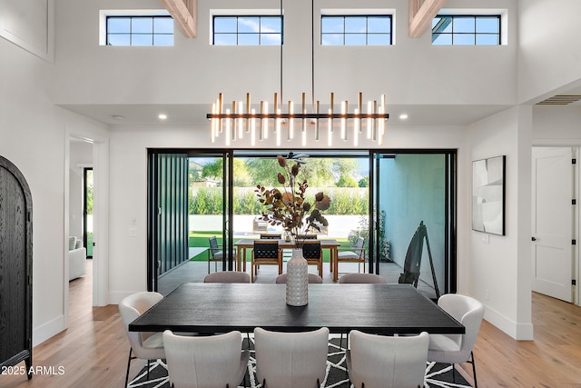 1013 W Ardmore Rd, Phoenix, AZ 85041 - dining space with a towering ceiling, light wood finished floors, and baseboards