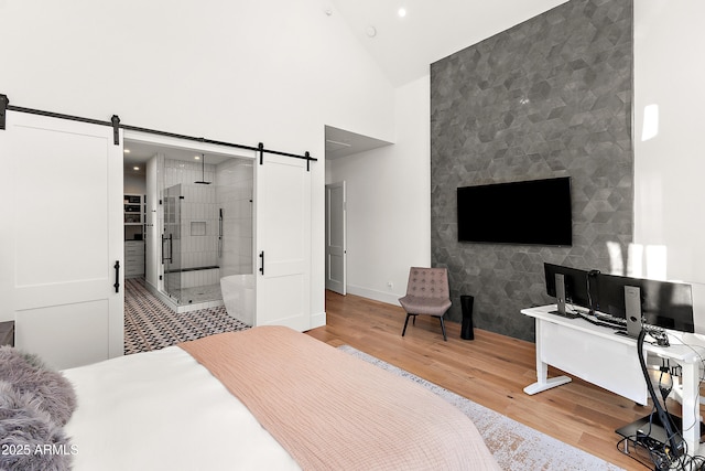 1013 W Ardmore Rd, Phoenix, AZ 85041 - bedroom featuring a barn door, wood finished floors, high vaulted ceiling, recessed lighting, and baseboards