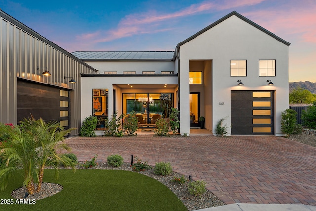 1013 W Ardmore Rd, Phoenix, AZ 85041 - contemporary home featuring stucco siding, a standing seam roof, decorative driveway, metal roof, and a front lawn