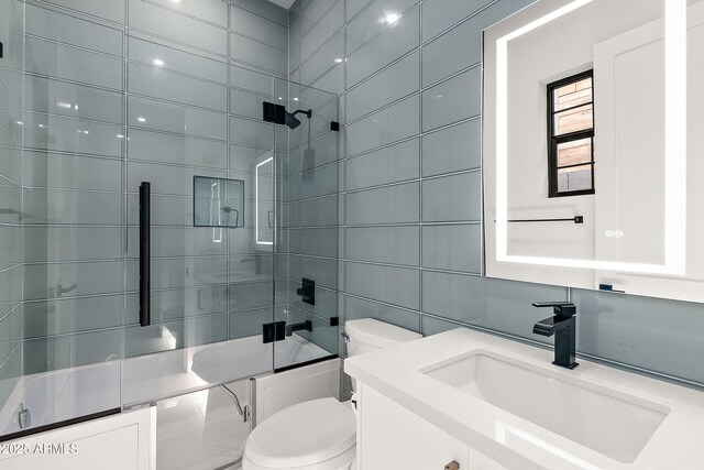 1013 W Ardmore Rd, Phoenix, AZ 85041 - full bath with toilet, tile walls, bath / shower combo with glass door, and vanity