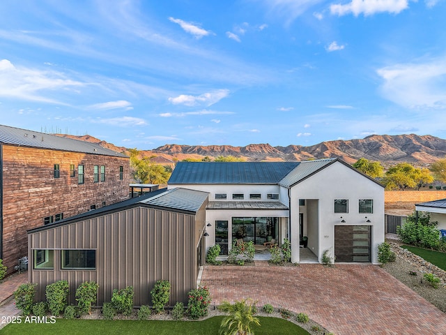 1013 W Ardmore Rd, Phoenix, AZ 85041 - view of front facade with a mountain view, decorative driveway, stucco siding, metal roof, and a standing seam roof