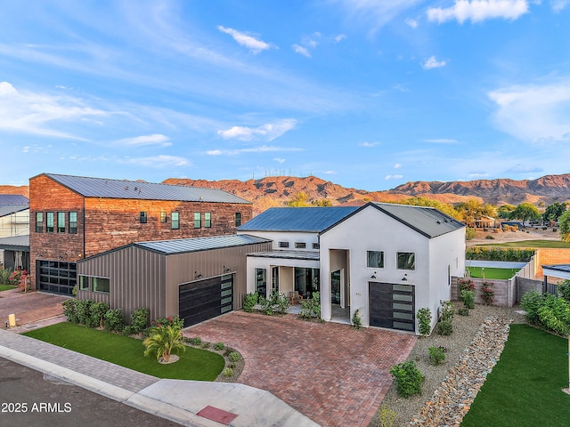 1013 W Ardmore Rd, Phoenix, AZ 85041 - contemporary house with a standing seam roof, a mountain view, metal roof, decorative driveway, and fence
