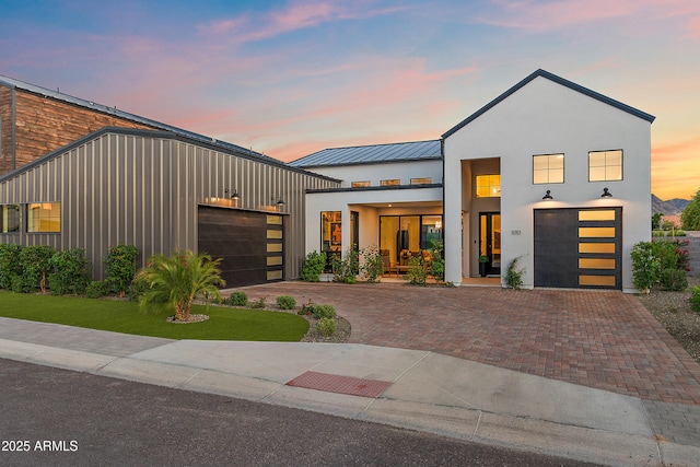 1013 W Ardmore Rd, Phoenix, AZ 85041 - view of front of property with a standing seam roof, decorative driveway, metal roof, and stucco siding