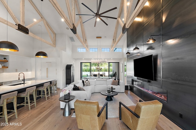 1013 W Ardmore Rd, Phoenix, AZ 85041 - living area with a towering ceiling, light wood finished floors, and a chandelier