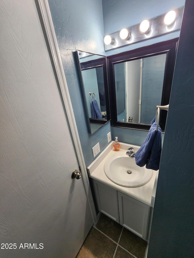 bathroom featuring tile patterned flooring and vanity
