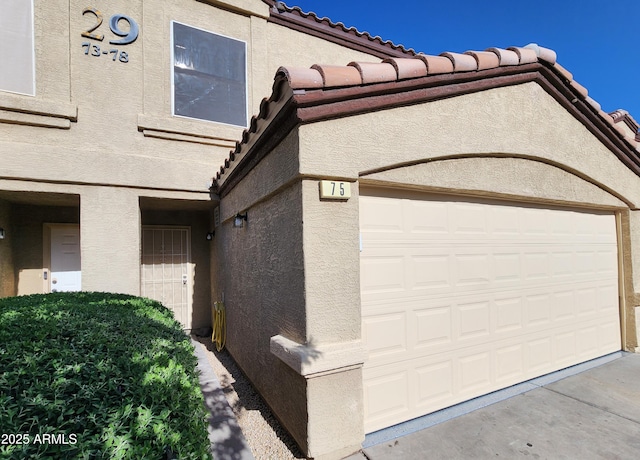 view of property exterior featuring a tiled roof and stucco siding