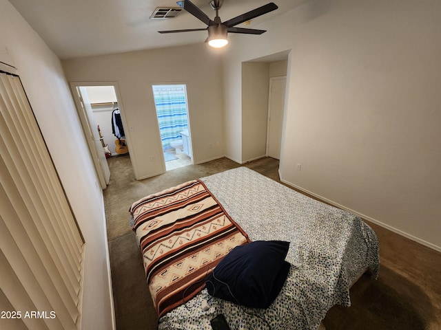 bedroom featuring a walk in closet, carpet floors, a ceiling fan, baseboards, and visible vents