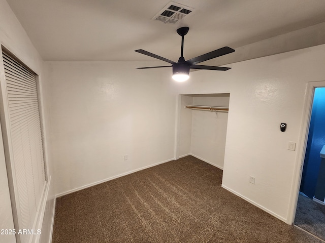 unfurnished bedroom with ceiling fan, visible vents, baseboards, a closet, and dark carpet