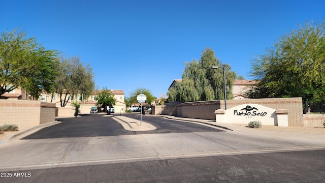 view of road featuring street lighting and curbs