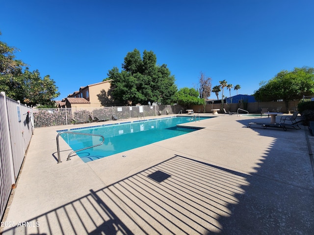 pool featuring fence and a patio