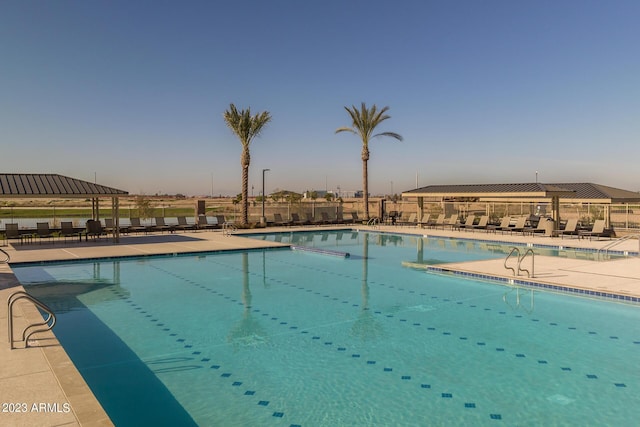 pool with fence and a patio