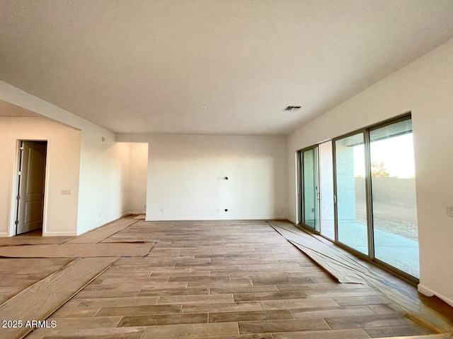 spare room with light wood-type flooring