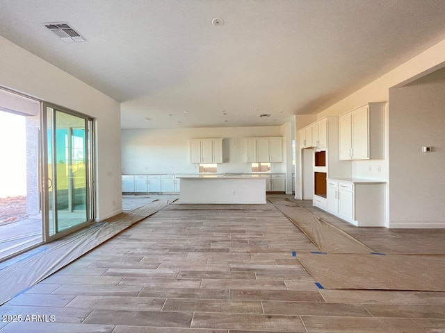 kitchen with white cabinetry and a kitchen island