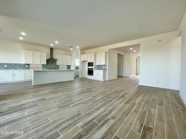 unfurnished living room with light hardwood / wood-style flooring