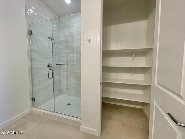 bathroom featuring an enclosed shower and tile patterned floors