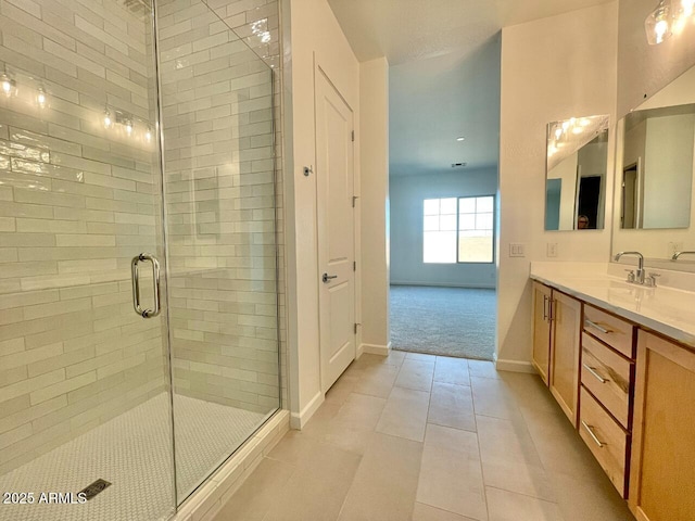 bathroom with tile patterned floors, vanity, and a shower with shower door