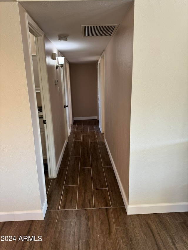 hallway with dark hardwood / wood-style floors