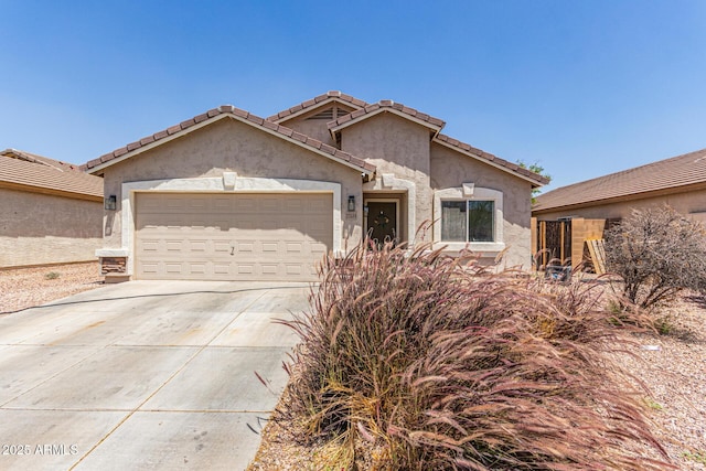 22534 W Pima St, Buckeye, AZ 85326 - view of front of home featuring a garage, driveway, stucco siding, and a tile roof