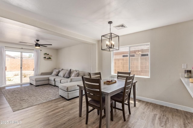 22534 W Pima St, Buckeye, AZ 85326 - dining area with wood finished floors, a chandelier, baseboards, and ceiling fan
