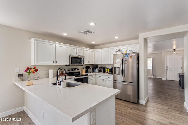 22534 W Pima St, Buckeye, AZ 85326 - kitchen featuring appliances with stainless steel finishes, baseboards, light countertops, a sink, and white cabinetry