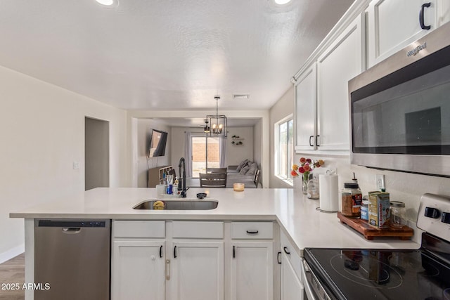 22534 W Pima St, Buckeye, AZ 85326 - kitchen with appliances with stainless steel finishes, a sink, a peninsula, and white cabinetry
