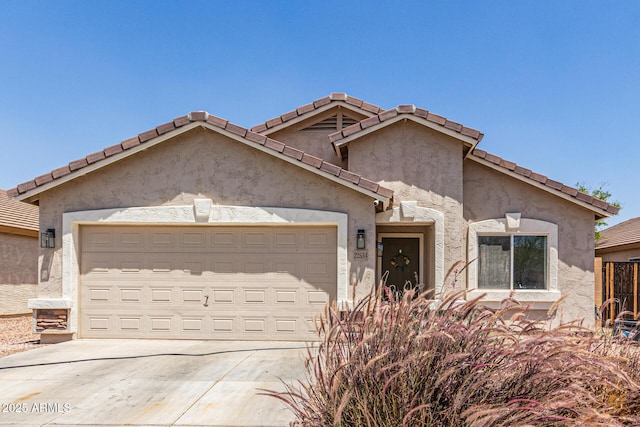 22534 W Pima St, Buckeye, AZ 85326 - view of front facade with concrete driveway, a garage, stucco siding, and a tile roof