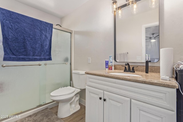 22534 W Pima St, Buckeye, AZ 85326 - bathroom featuring a stall shower, wood finished floors, vanity, and toilet