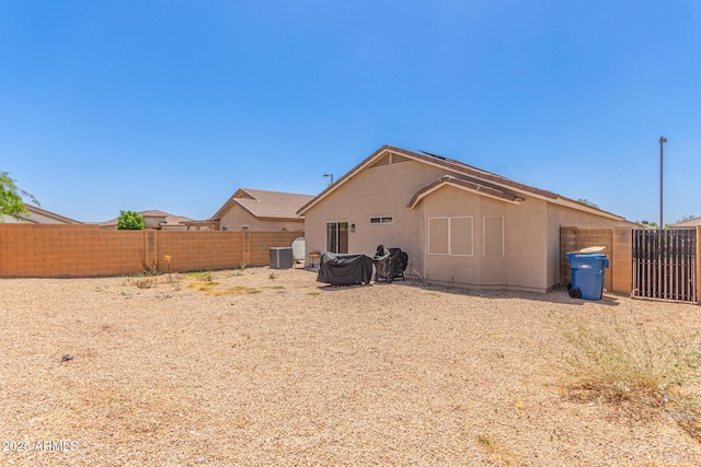 22534 W Pima St, Buckeye, AZ 85326 - back of house featuring a fenced backyard, stucco siding, and central AC unit