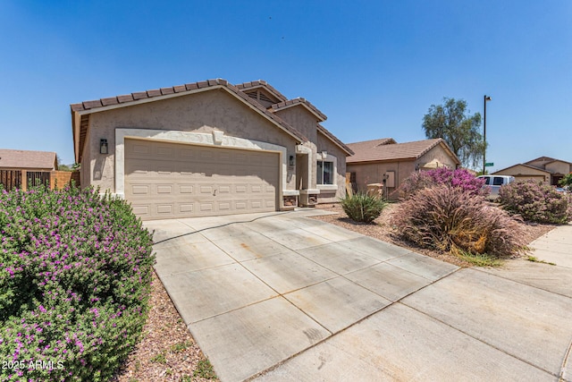 22534 W Pima St, Buckeye, AZ 85326 - ranch-style house with concrete driveway, a garage, stucco siding, and a tiled roof
