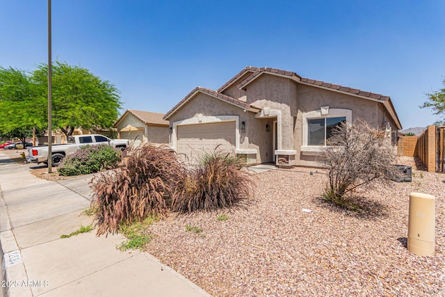 22534 W Pima St, Buckeye, AZ 85326 - ranch-style house featuring an attached garage, stucco siding, fence, a tiled roof, and driveway