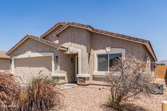 22534 W Pima St, Buckeye, AZ 85326 - view of front of house with a garage, stucco siding, and a tile roof