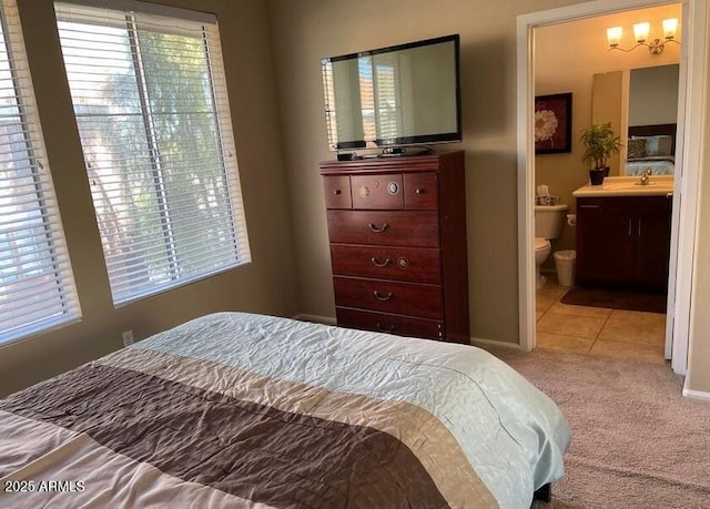 6605 N 93rd Ave Unit 1071, Glendale, AZ 85305 - bedroom featuring a sink, carpet flooring, connected bathroom, baseboards, and tile patterned floors