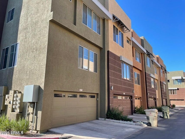 6605 N 93rd Ave Unit 1071, Glendale, AZ 85305 - view of building exterior with concrete driveway and a garage