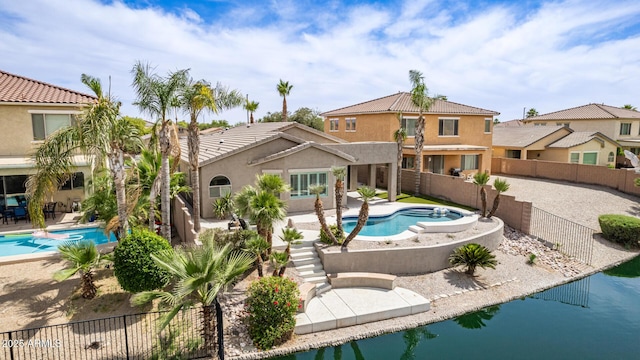 896 E Indian Wells Pl, Chandler, AZ 85249 - rear view of house featuring a patio area, a fenced backyard, stucco siding, a jacuzzi, and a tiled roof